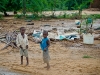 boys-with-the-salvaged-materials-from-their-collapsed-home